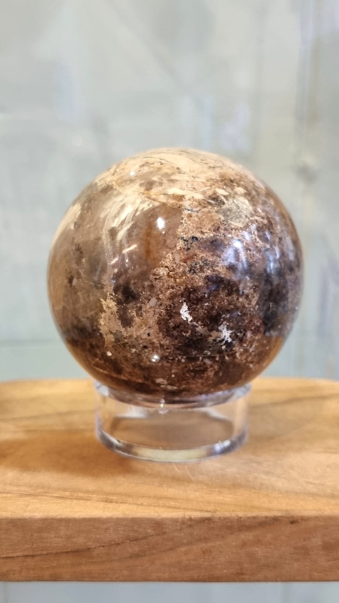 Nurturing and grounding, a chocolate opal crystal sphere with stand.