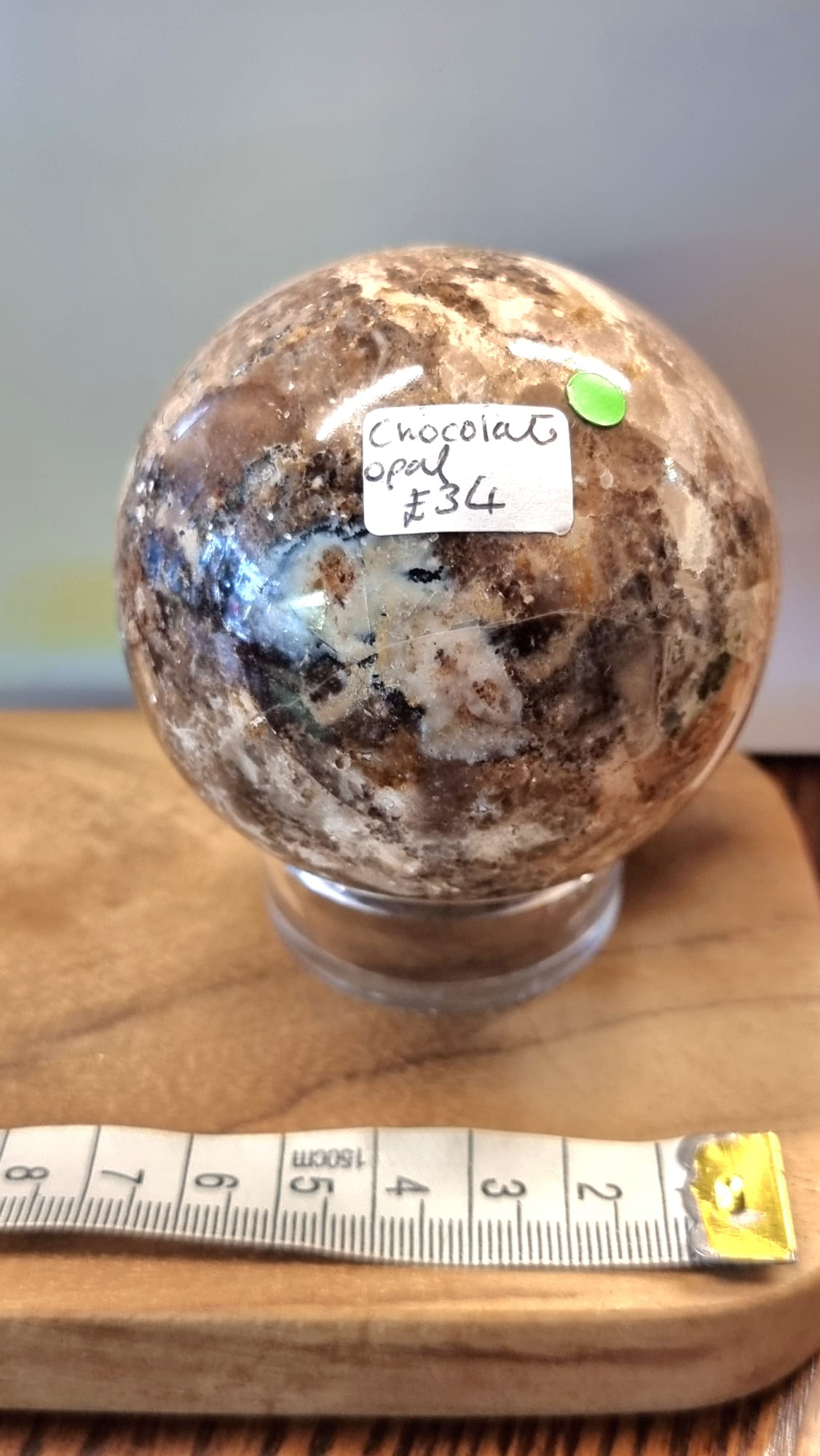 Nurturing and grounding, a chocolate opal crystal sphere with stand.