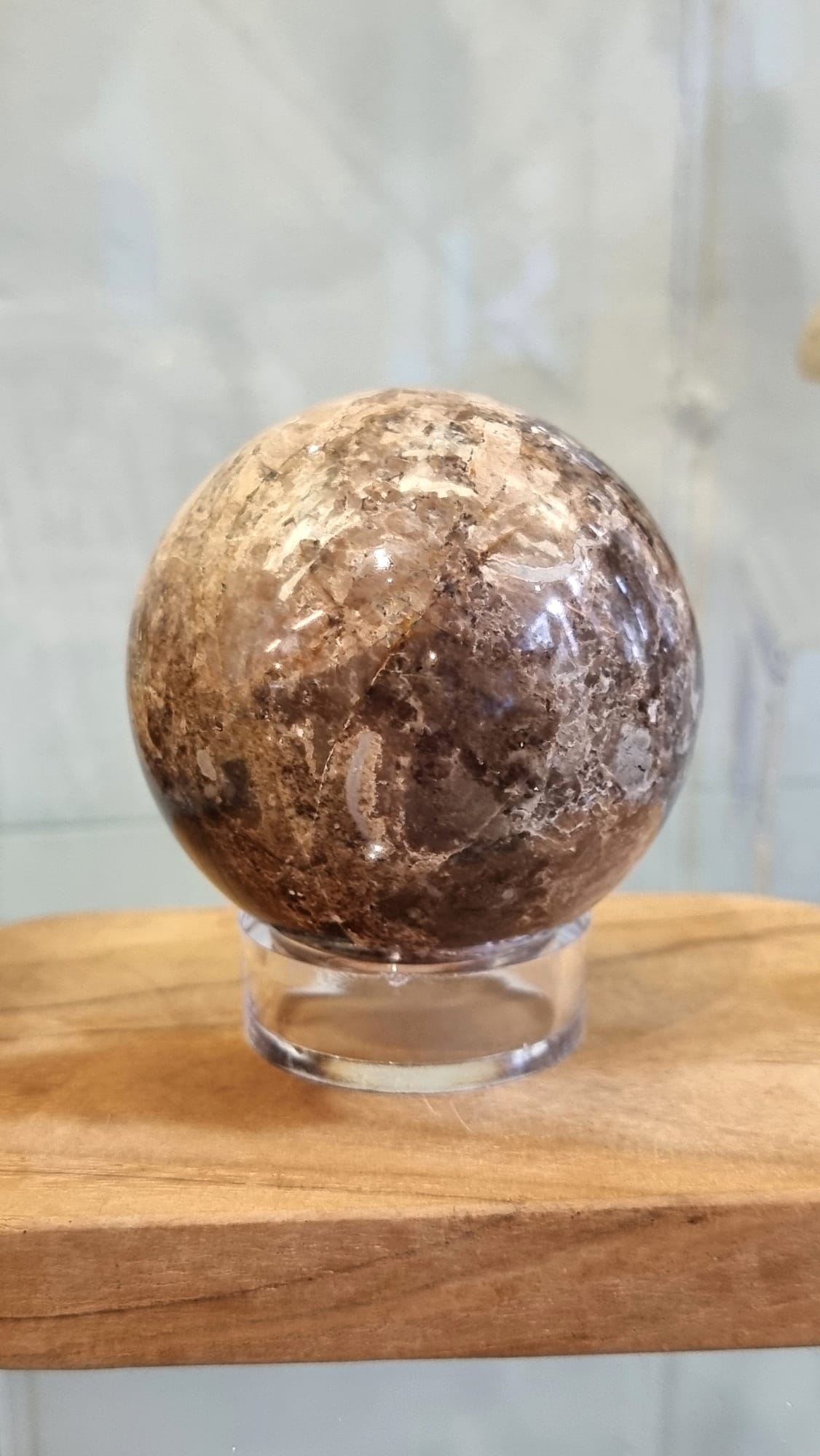 Nurturing and grounding, a chocolate opal crystal sphere with stand.