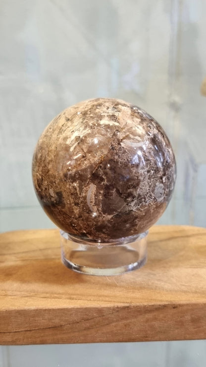 Nurturing and grounding, a chocolate opal crystal sphere with stand.