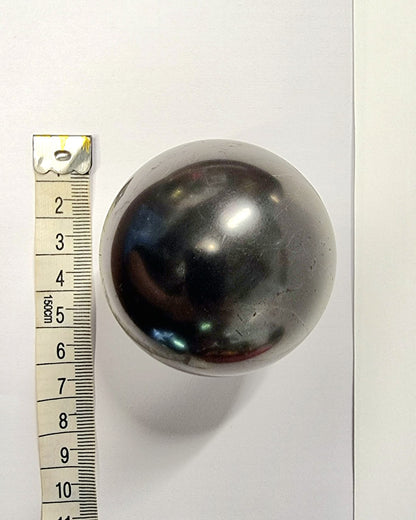 Polished shungite sphere used to absorb negative energy and electromagnetic fog.