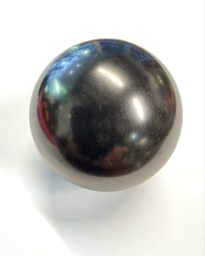 A polished shungite sphere used to absorb negative energy and EMF.
